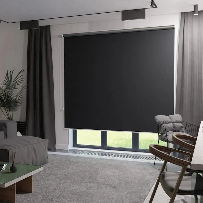 Bedroom with a navy roller blind lowered over the window