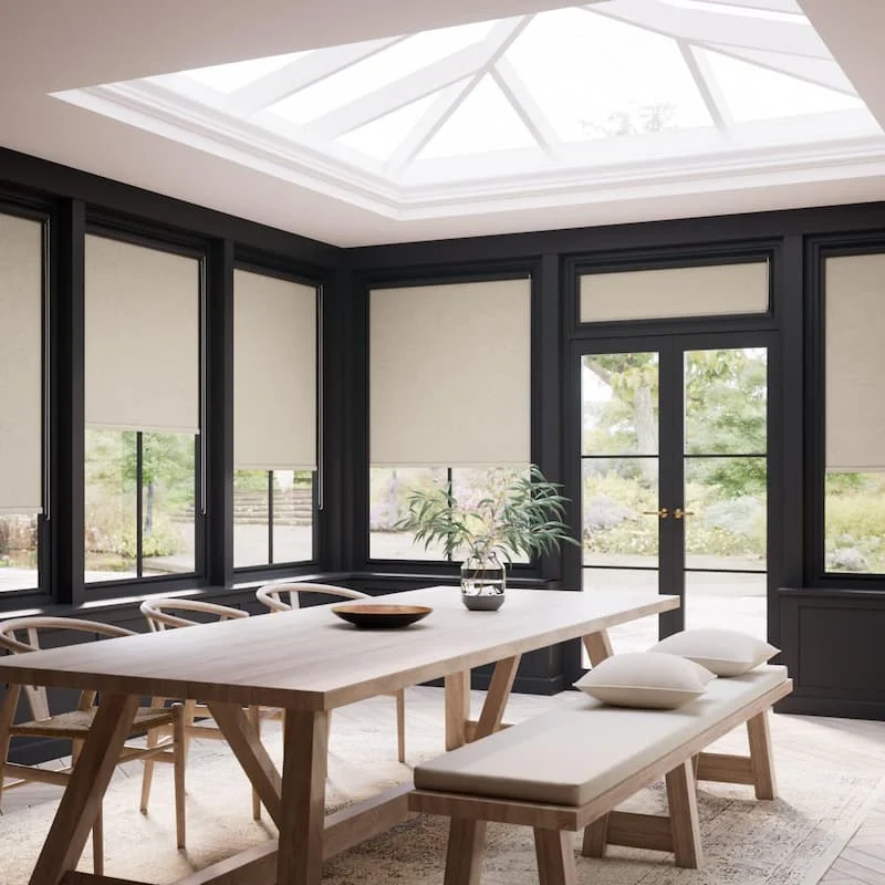 Bright garden room with tall glazed windows and plants