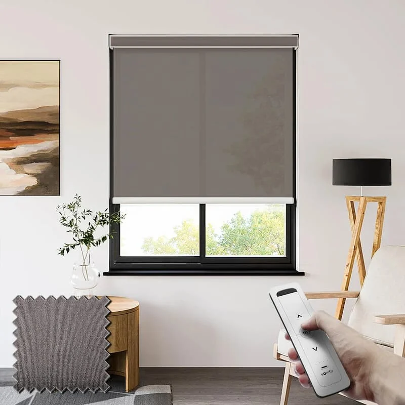 Modern bedroom with dark roller blinds on a wide window