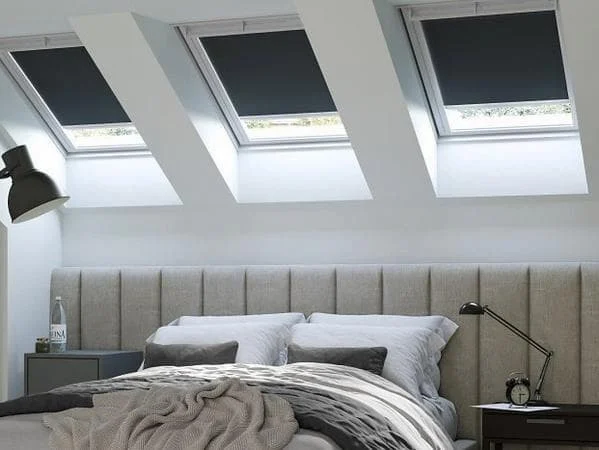 Loft bedroom with a roof window set into the sloping ceiling