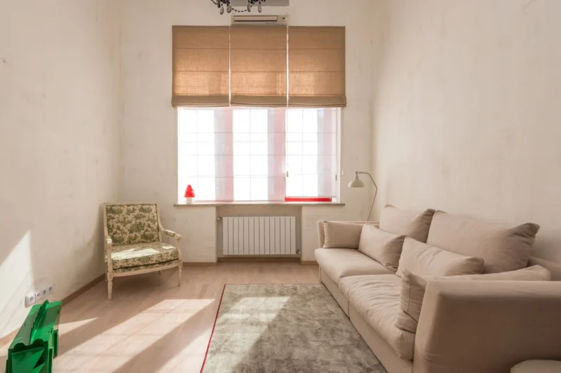 Blinds over radiators: a fabric blind at a living room window with a radiator below