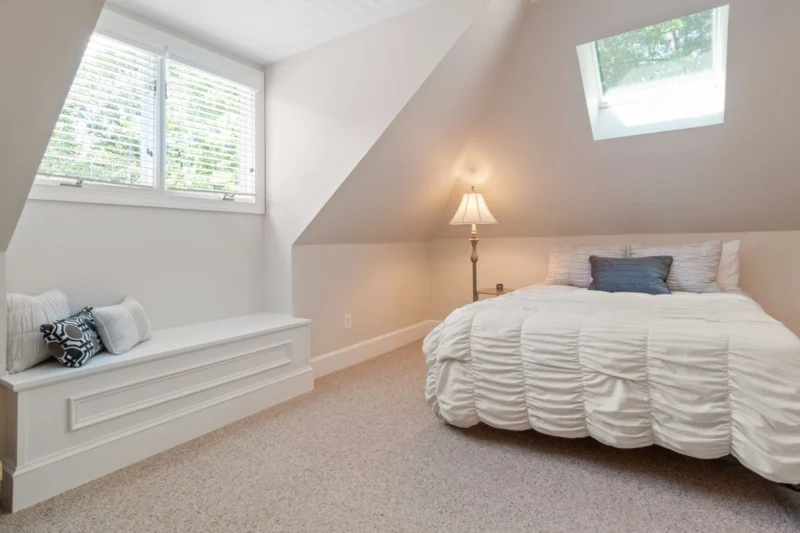 Dormer window blinds suit attic bedrooms like this one with a dormer and a roof window