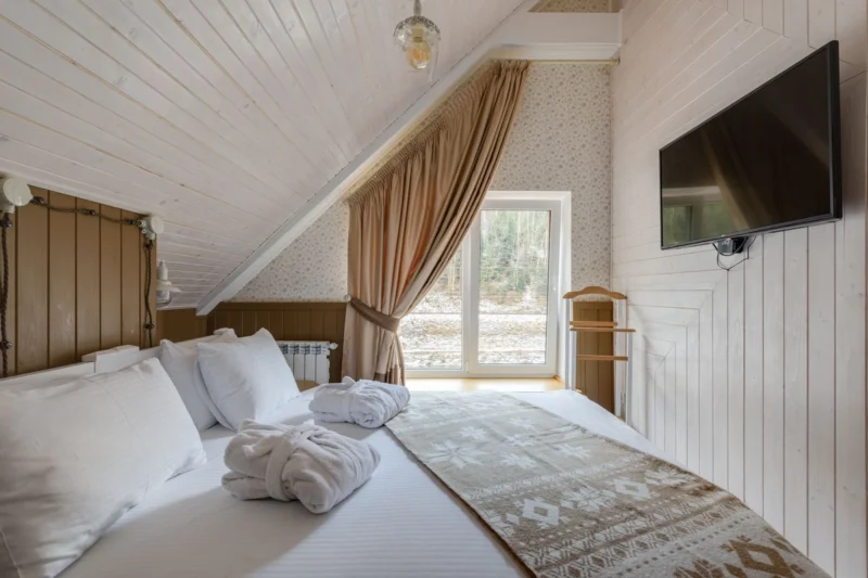 Loft bedroom with a sloping ceiling and a small window