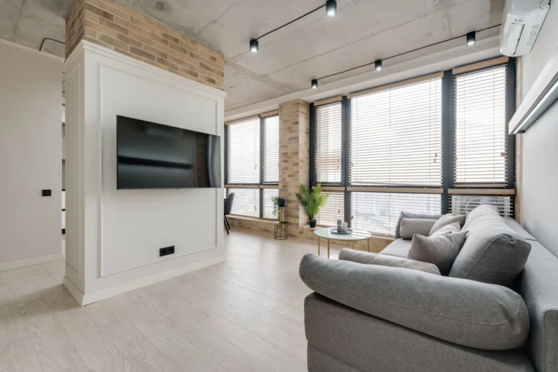 Living room with a grey sofa and large windows