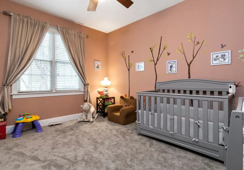 Child's nursery with a cot and two windows