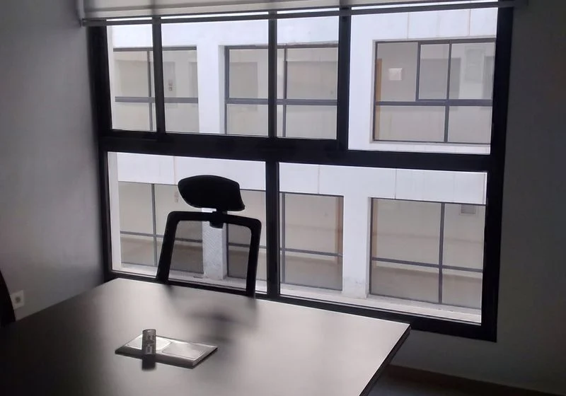 Office desk in front of a large window