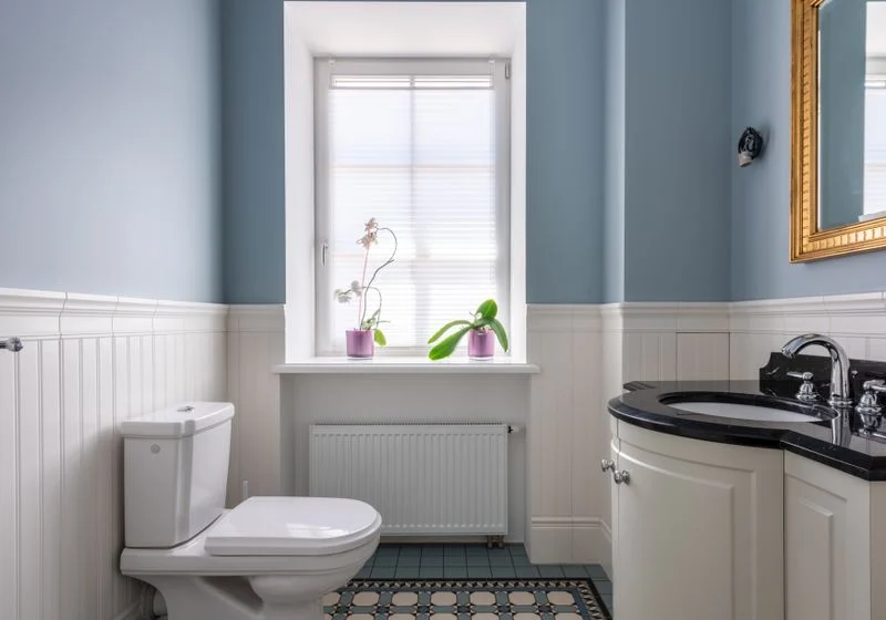 Bright bathroom with a single window above the sink area
