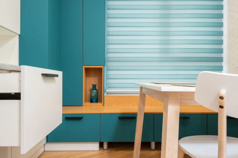 How long do roller blinds last? A day and night roller blind in a teal kitchen