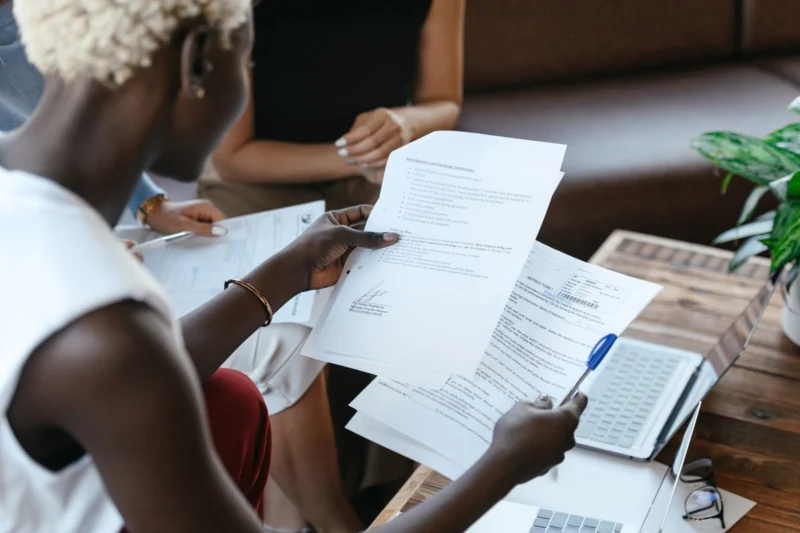 Person comparing printed documents at a desk