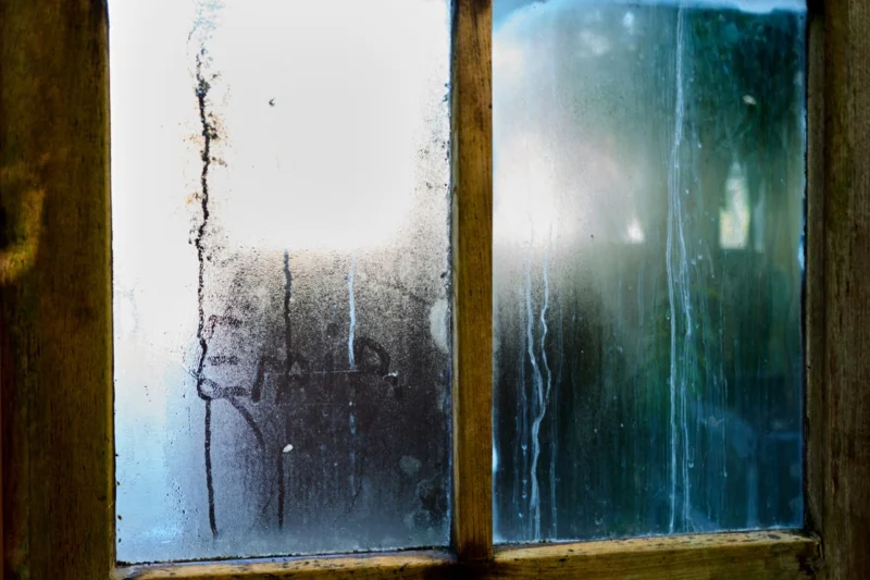 Condensation running down the inside of a window pane