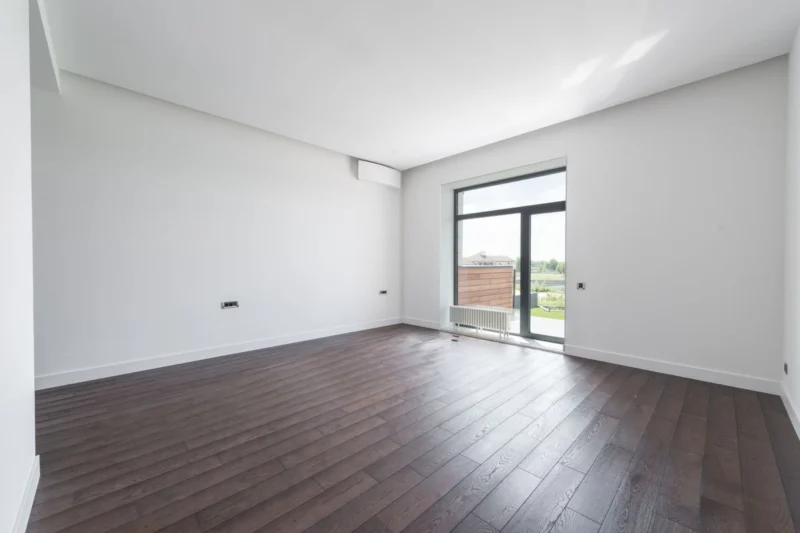 Empty room in a new home with bare windows, waiting for blinds