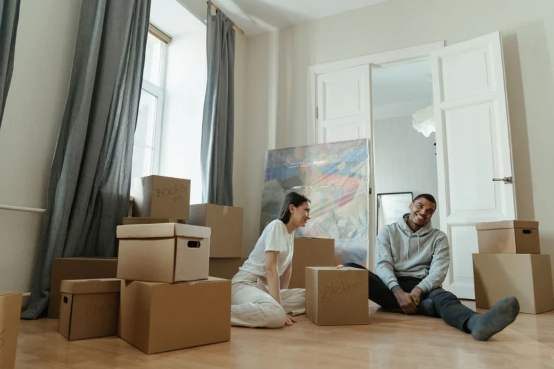 Couple unpacking moving boxes in a new home